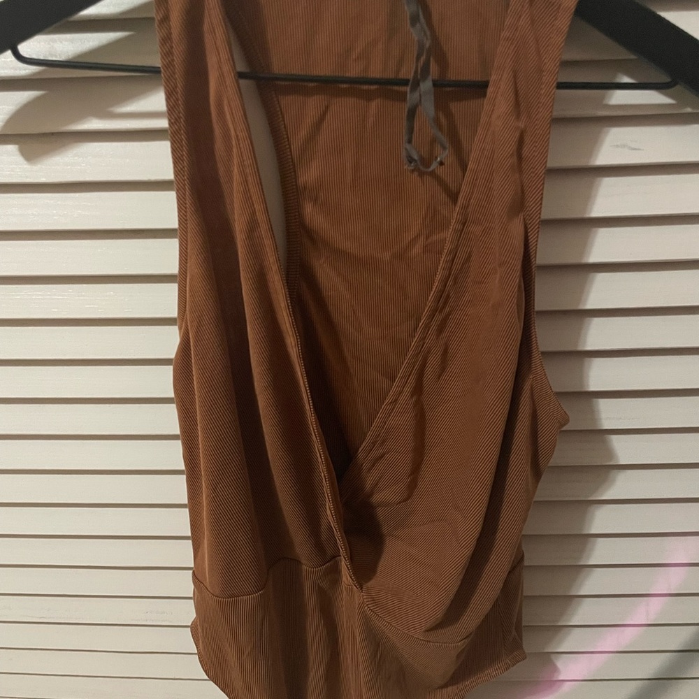 Caramel color one piece top. Deep v neck.